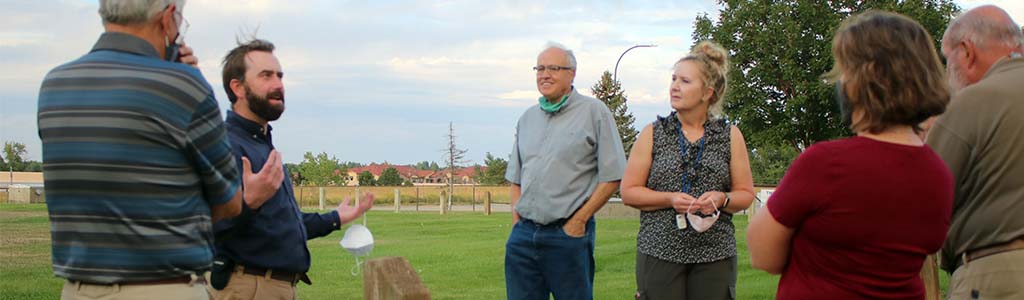 Staff member speaks to a group of 5 people during a tour of the water treatment plant