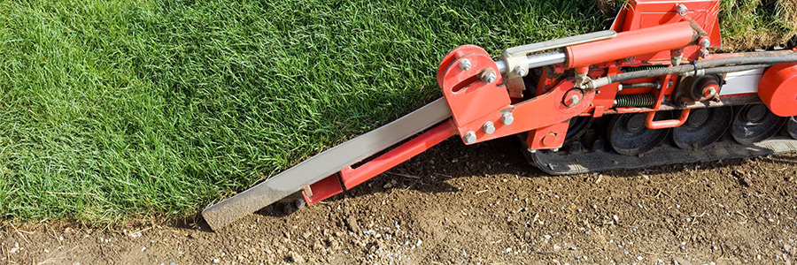 A sod cutter is cutting away grass