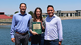 Three Centennial Water staff members holding finance award plaque.